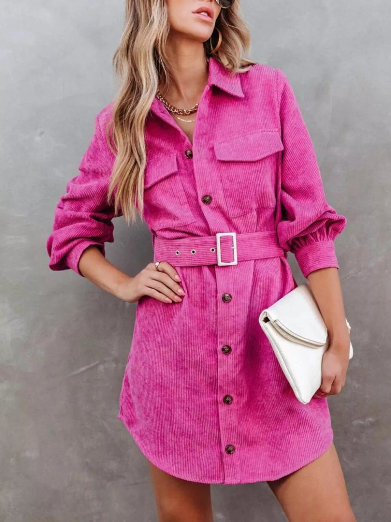 Pink corduroy shirt dress with belt and button front detail.