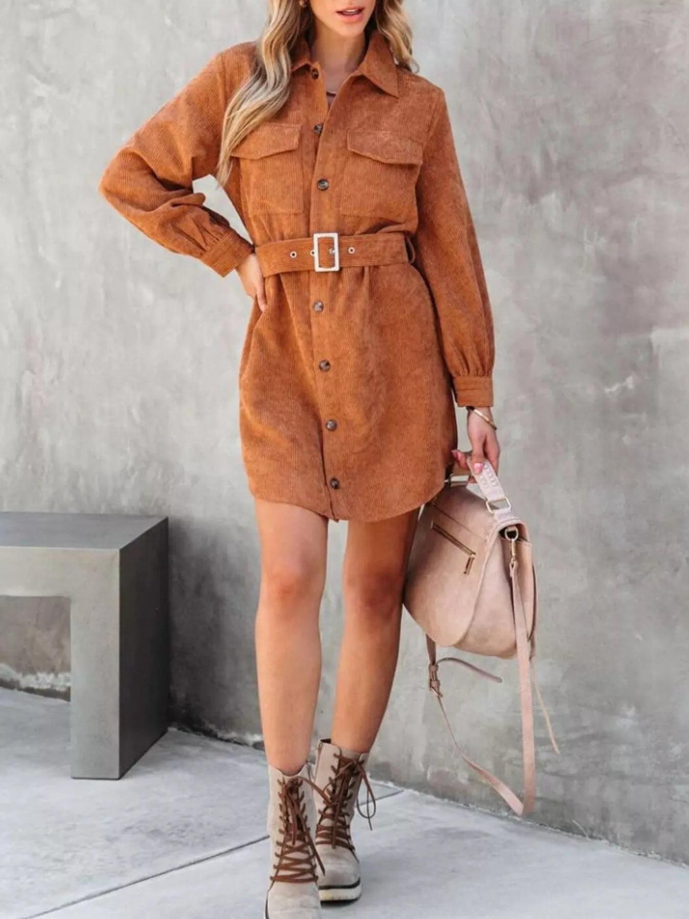 Rust brown corduroy shirt dress with belted waist and button front closure.