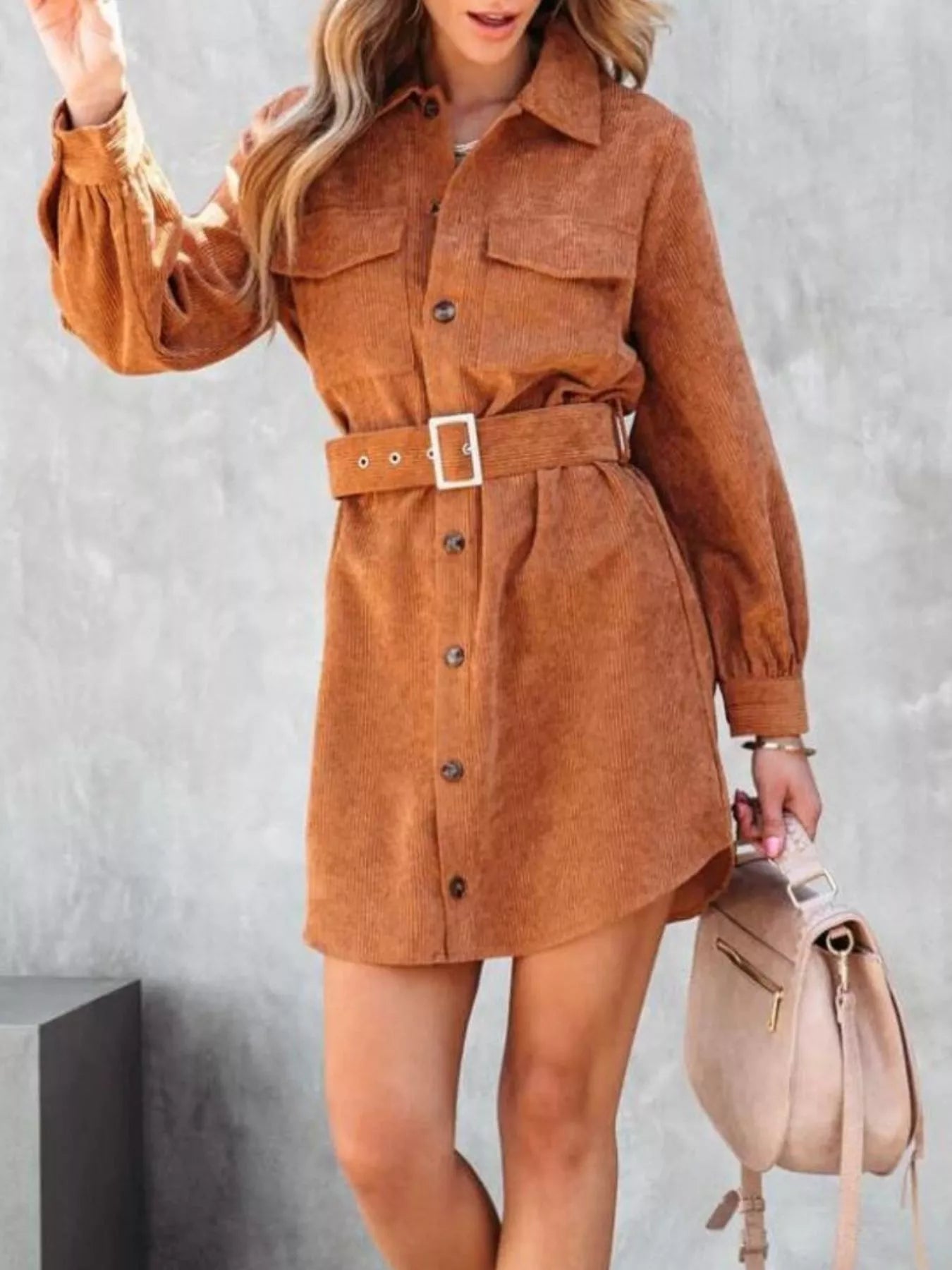 Rust corduroy shirt dress with belt and button front closure.