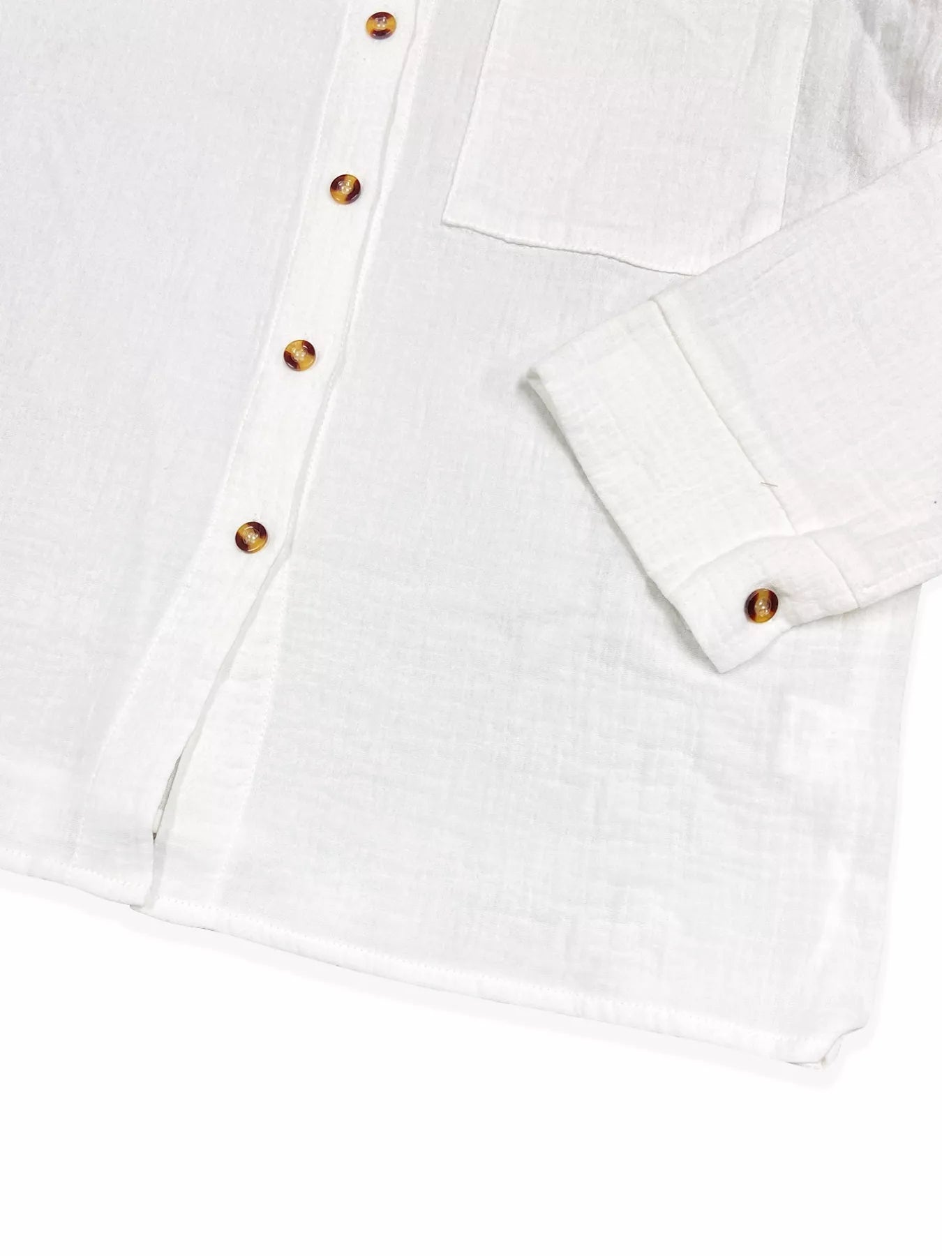 White button-up shirt with tortoiseshell buttons, long sleeves, and lightweight cotton fabric.