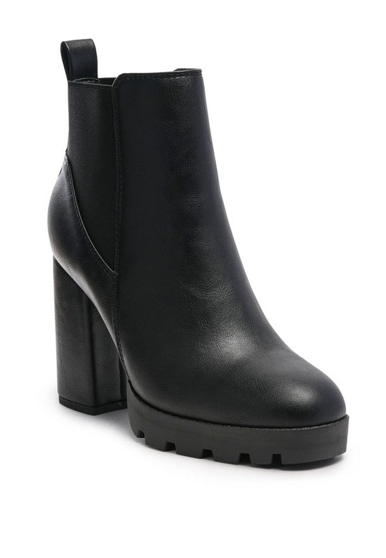 Black leather ankle boot with chunky heel and lug sole for added traction