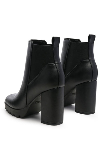Black platform ankle boots with chunky high heels and faux leather finish.
