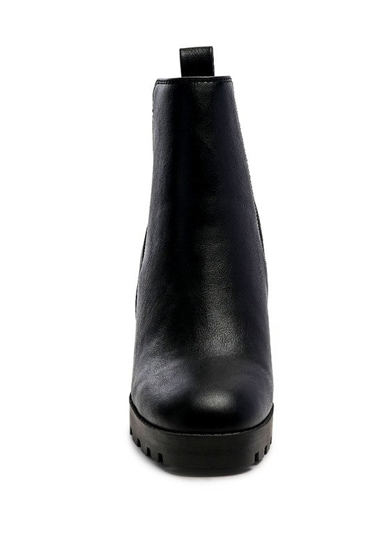 Black Chelsea boot, leather upper, ankle-height design with pull tab and lug sole for better grip.