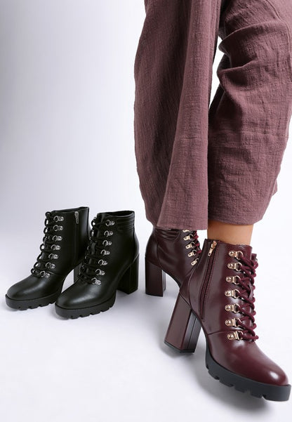 Burgundy and black lace-up heeled ankle boots with side zipper and chunky lug sole in faux leather.