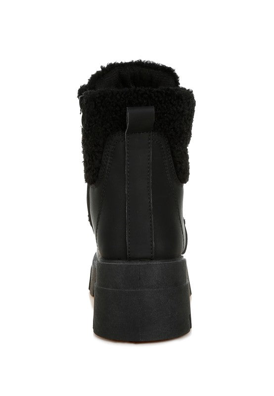 Black ankle boot with faux shearling lining and platform sole.