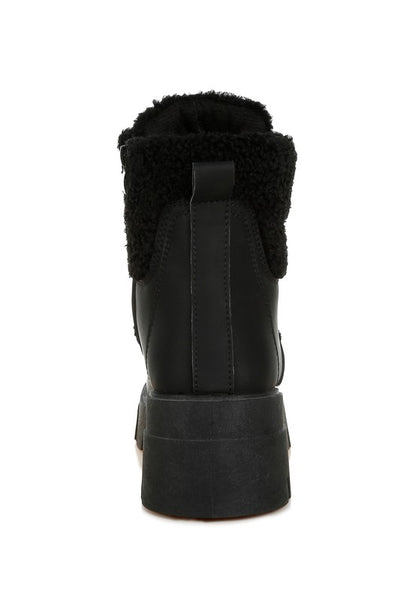 Black ankle boot with faux shearling lining and platform sole.