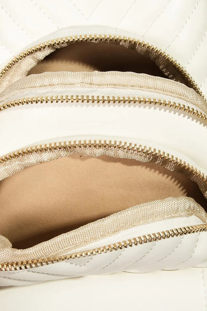 Cream quilted backpack with gold zippers and soft fabric lining