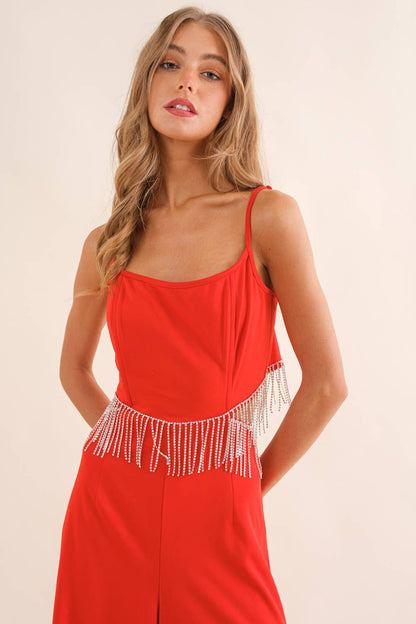 Red fringe jumpsuit with spaghetti straps and rhinestone beaded waist detail.