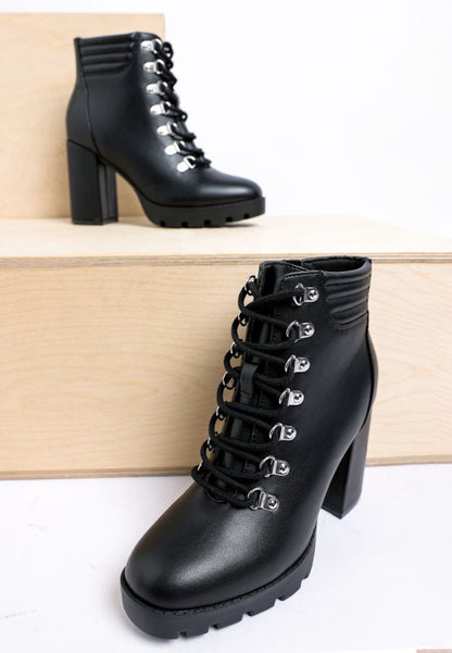 Black lace-up ankle boots with chunky heel and silver eyelets, made from faux leather.