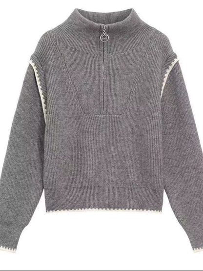 Gray knit sweater with zipper detail, high collar, and ribbed wool-blend fabric