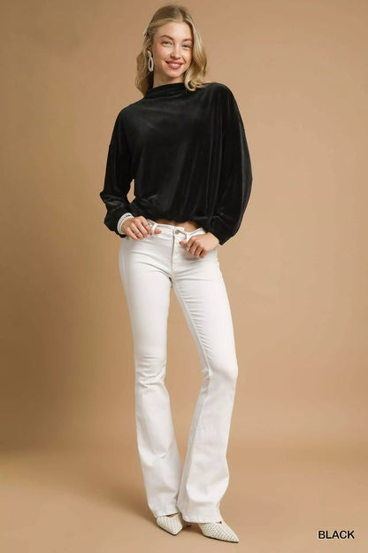 Black velvet long-sleeve top with mock neck and gathered hem.