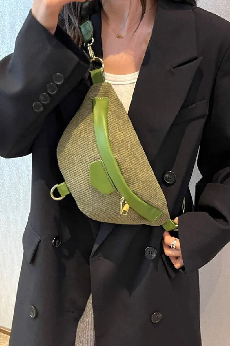 Olive green corduroy sling bag with leather accents and a gold zipper closure.