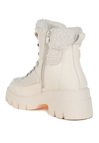 Ivory combat boot with faux shearling panels and side zipper for added warmth and style