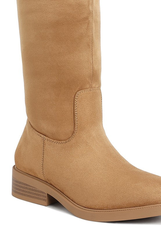 Tan suede knee-high boots with a low stacked heel and almond toe design