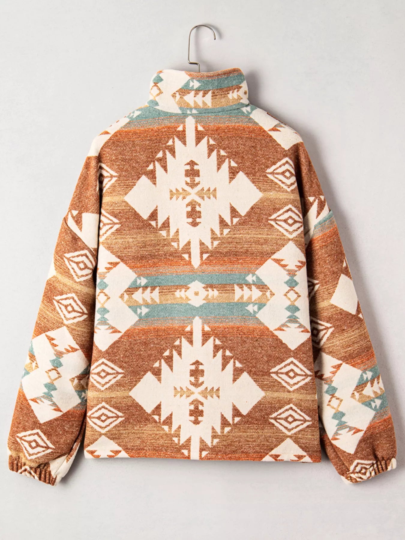 Brown and cream patterned fleece jacket with mock neck and geometric tribal print.