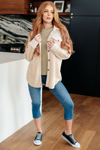 Cream fleece button-up jacket with long sleeves and sherpa material.