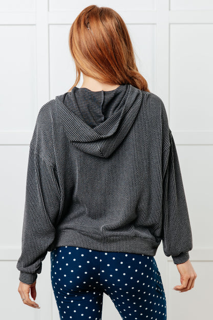 Charcoal waffle knit hoodie with drop shoulders and relaxed fit.