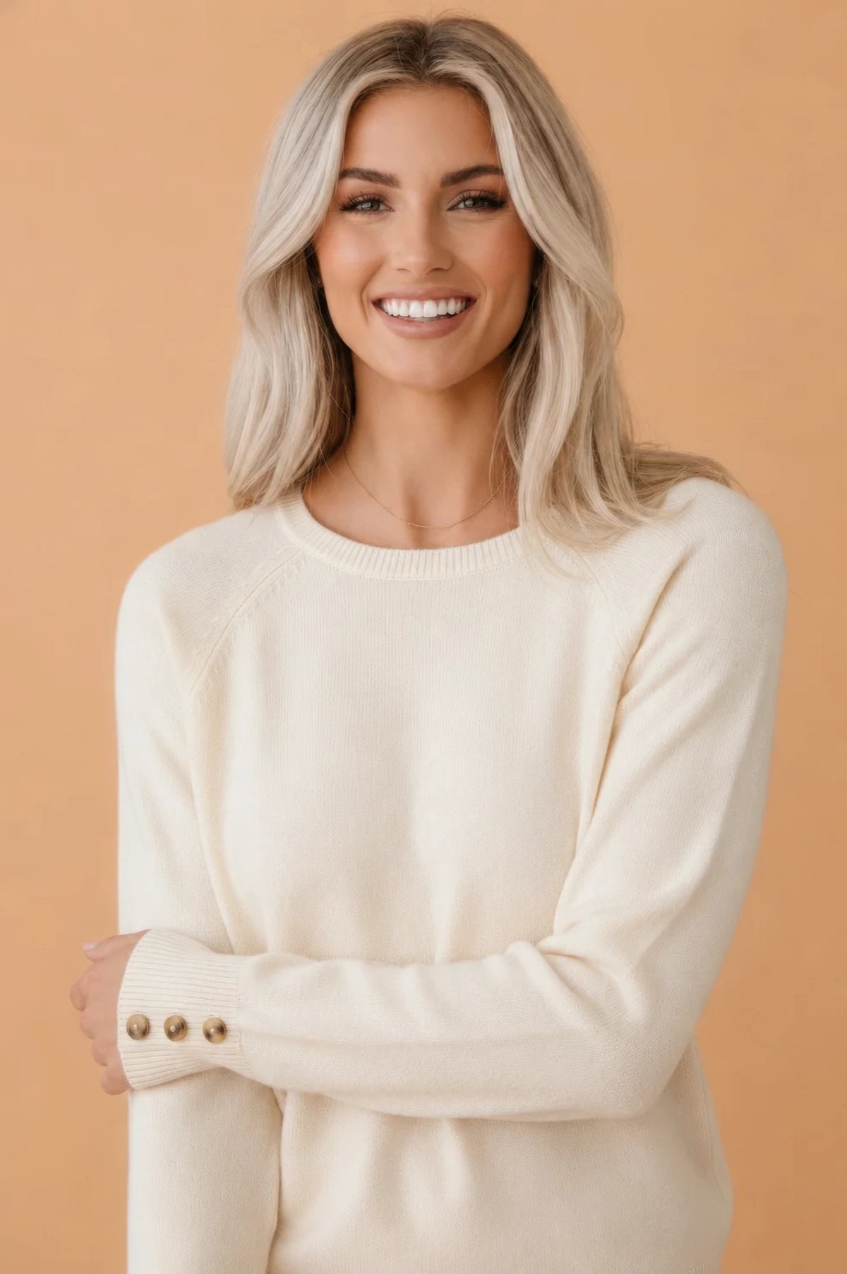 Solid buttoned bishop-sleeve crew neck sweater in white or camel