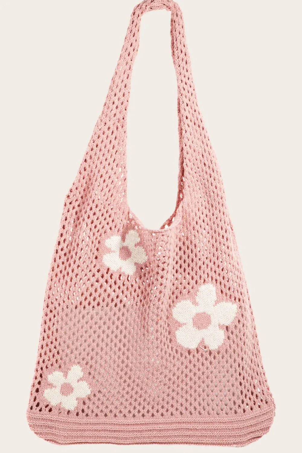 Pink crochet tote bag with white flower patterns and open mesh design.
