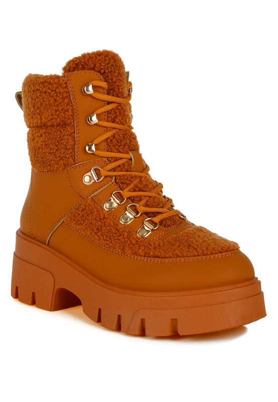 Rust orange hiking boot with faux shearling panels and chunky rubber sole.