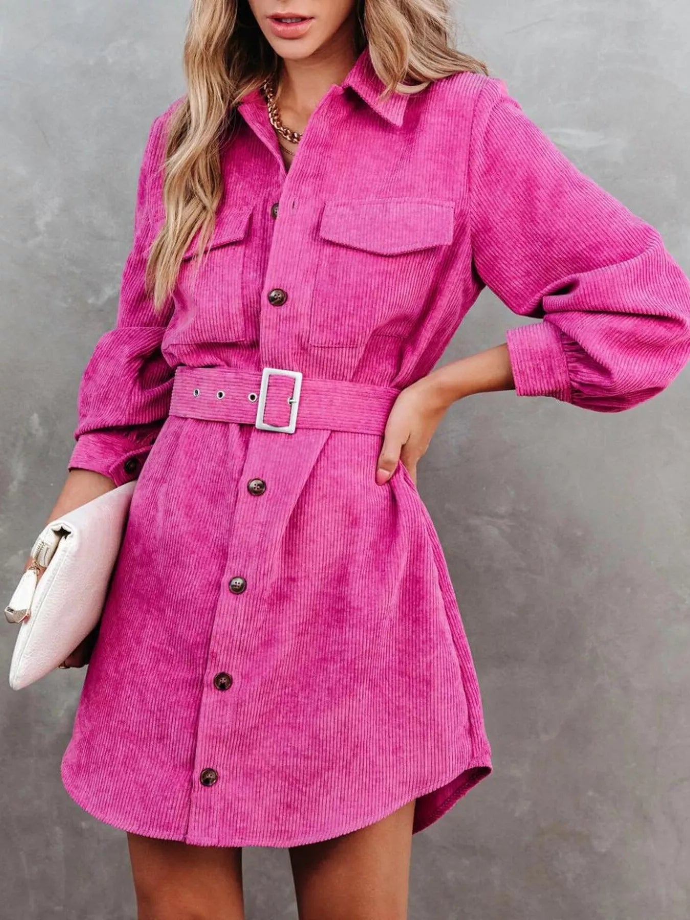 Pink corduroy shirt dress with belt and button front detail.