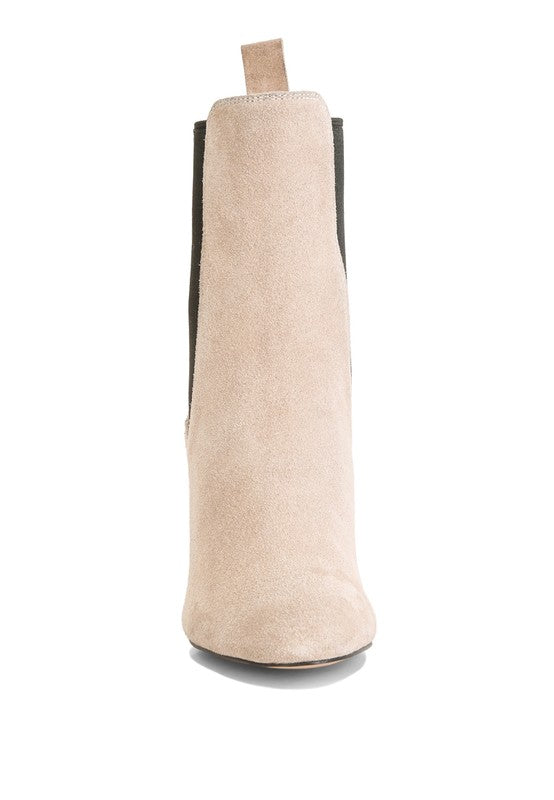 Beige suede ankle boot with black side panels and pull tab.