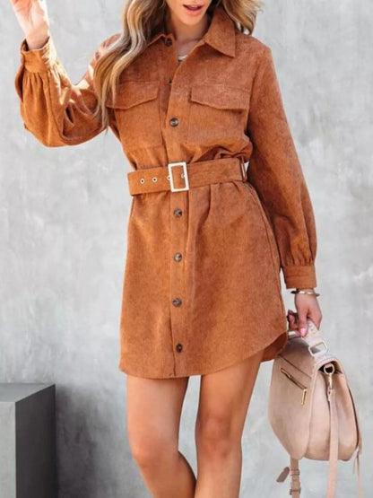 Rust corduroy shirt dress with belt and button front closure.