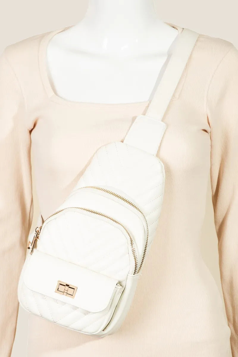 White quilted sling bag with gold zippers and adjustable strap.