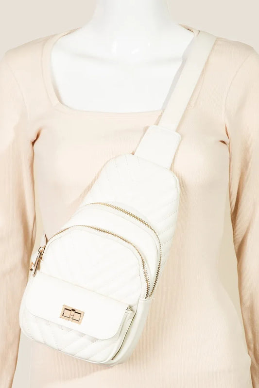 White quilted sling bag with gold zippers and adjustable strap.