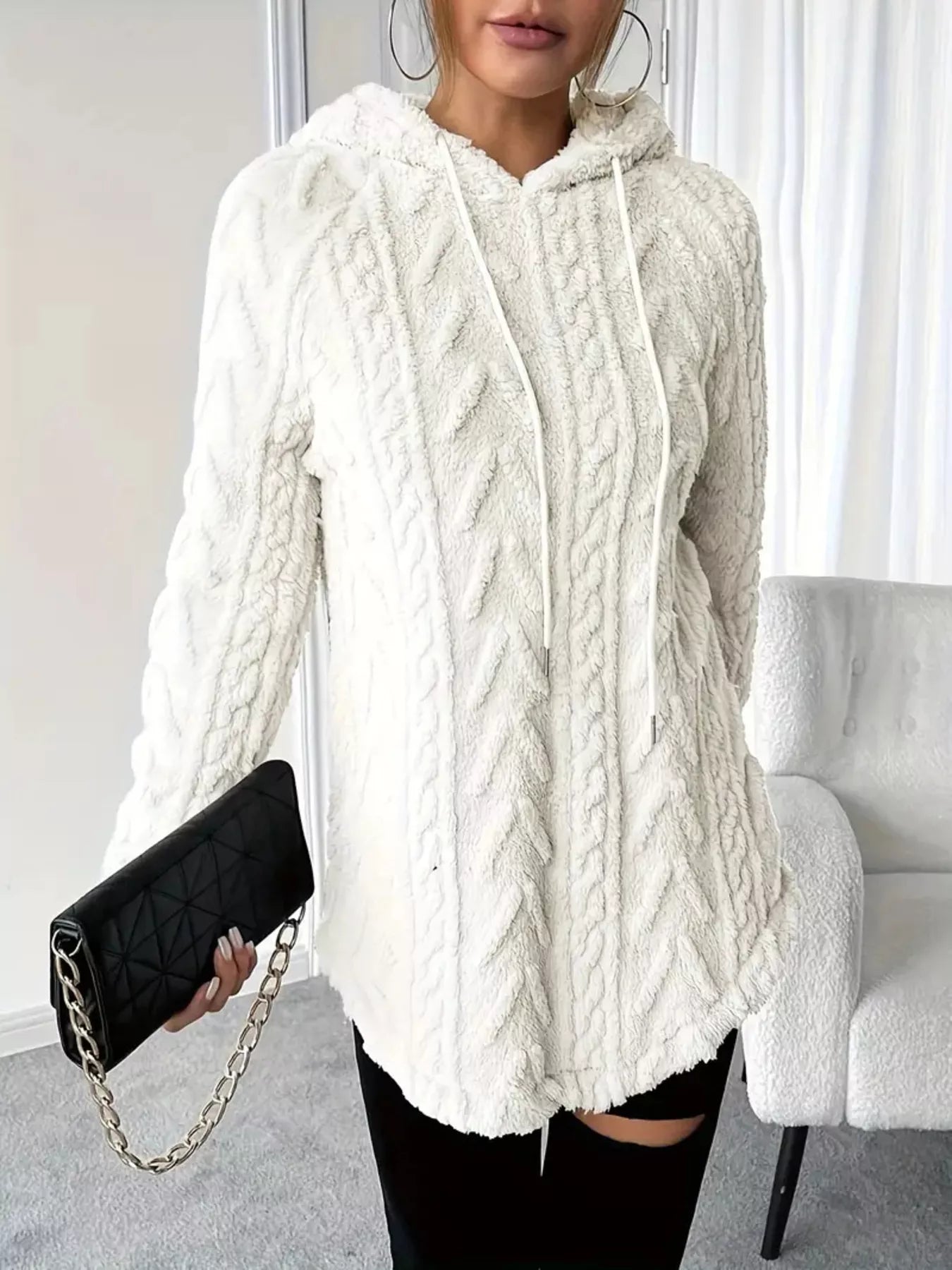 White cable knit hoodie, long-sleeve pullover style with soft fleece fabric.