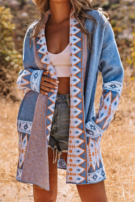 Person wearing a patterned cardigan in an outdoor setting