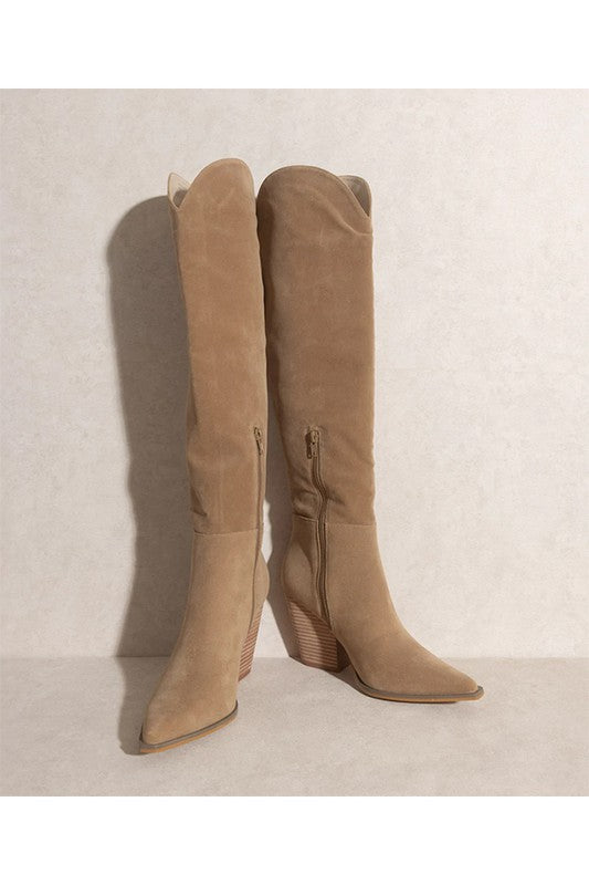 Tan suede knee-high boots with pointed toes and stacked block heels.