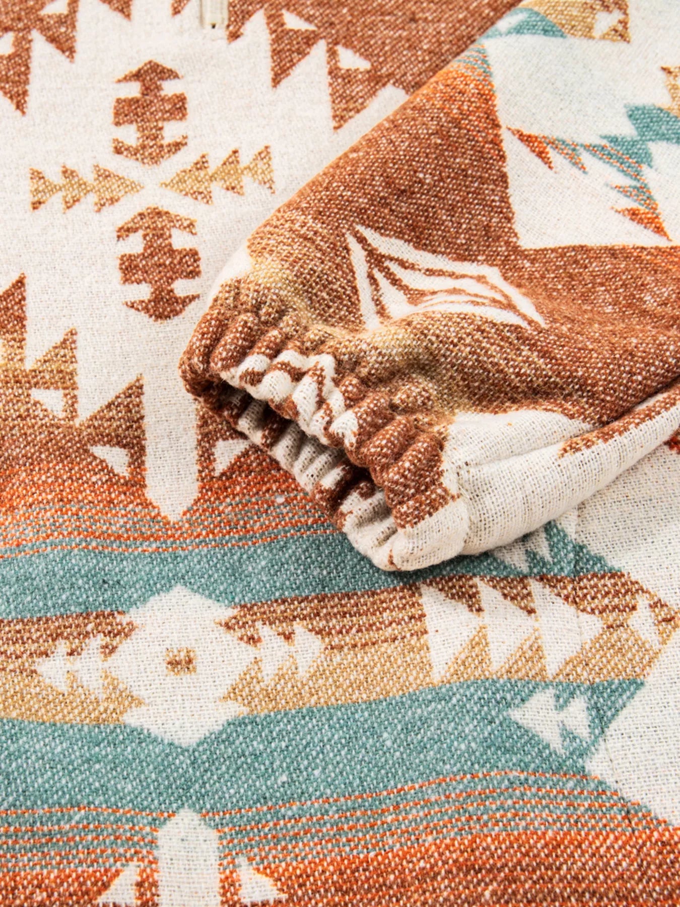 Southwest Print Pullover, rust multi-color, fleece hoodie with elastic cuffs and woven cotton material.