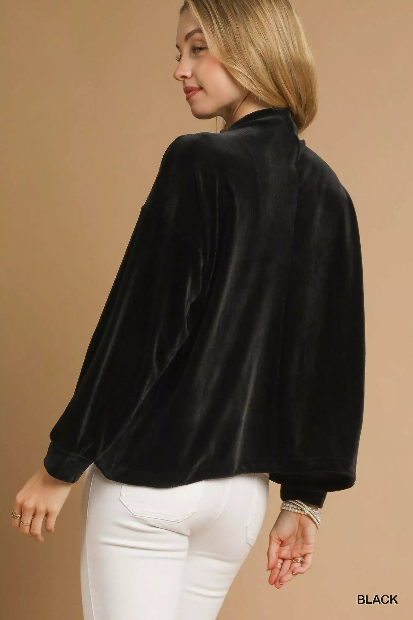 Black velvet long-sleeve blouse with relaxed fit and soft texture.