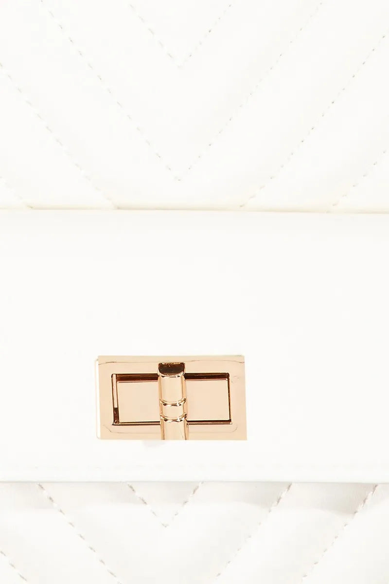 White quilted leather handbag with gold-tone turn-lock closure