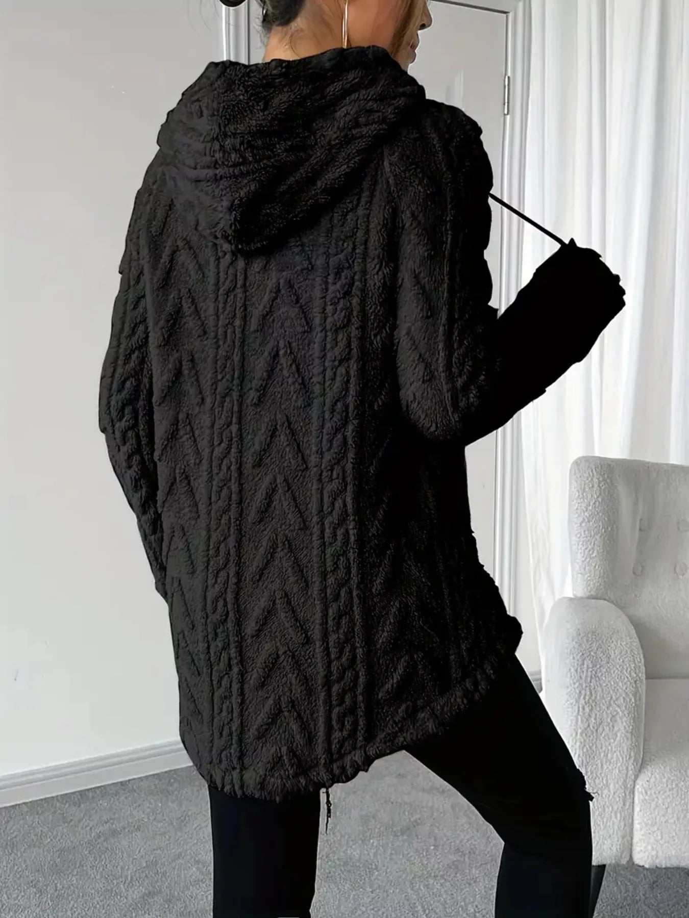 Black hooded sweater with drawstring, knit-textured fleece for warmth and comfort